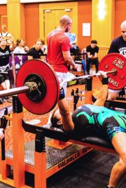 Geelong powerlifting coach Ingrid Barclay on the bench press in green
